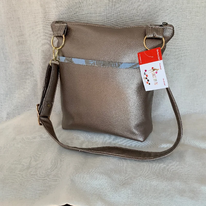 Top Brand Discounts Metallic vinyl crossbody with exterior slip pockets and interior zip pockets. Top Brand Discounts Metallic vinyl crossbody with exterior slip pockets and interior zip pockets.