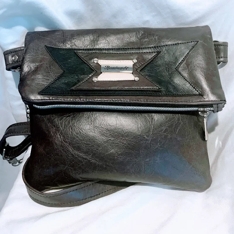Luxury Bags With Premium Materials And Craftsmanship Gray leather fold over bag with adjustable crossbody strap Luxury Bags With Premium Materials And Craftsmanship Gray leather fold over bag with adjustable crossbody strap